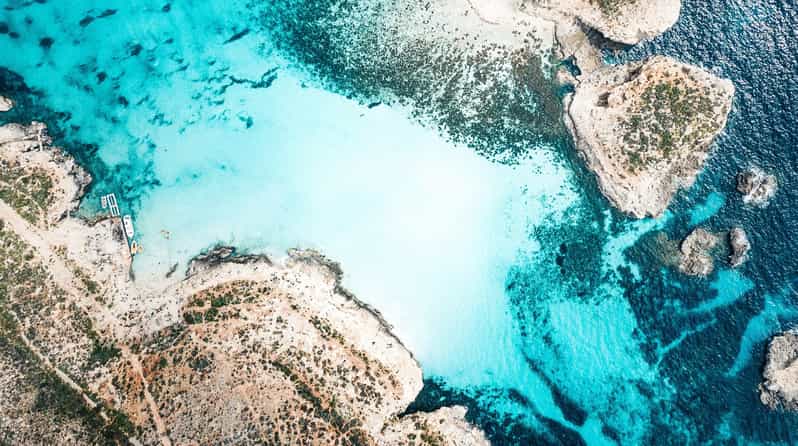 From Mellieha: Three Bay Cruise including the Blue Lagoon - The Blue Lagoon: beautiful water, busy shore